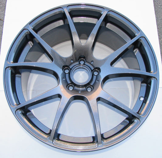 Car wheel rim with a metallic finish on a white background